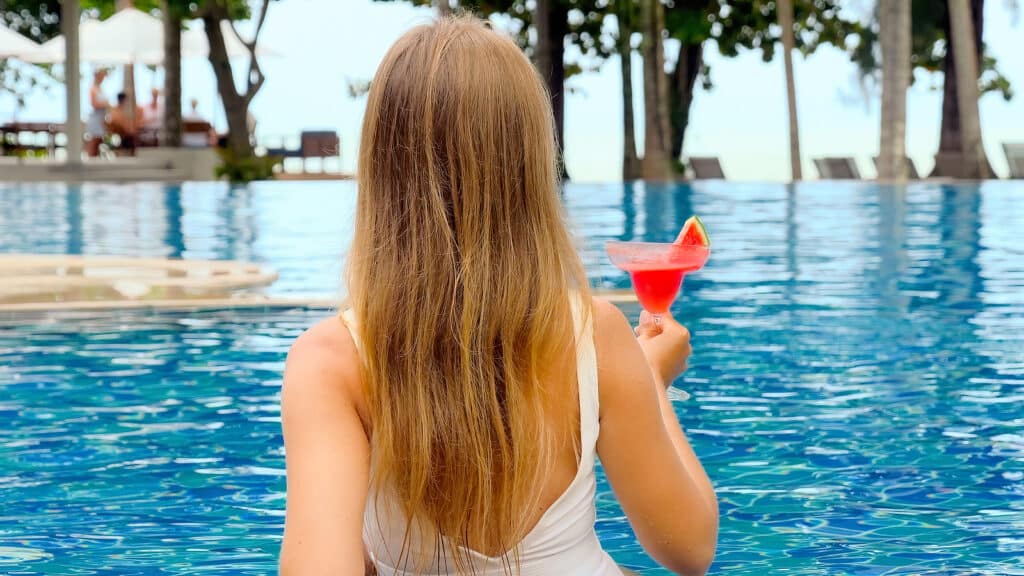 Back View Of Woman Enjoy Summer Vacation In Luxury Beach Resort.